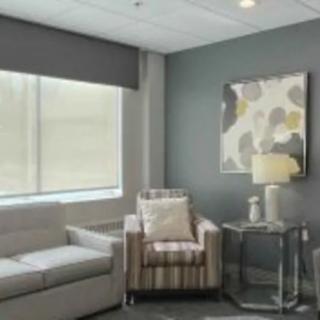 A modern living room with a cozy sofa, armchair, and stylish decor.