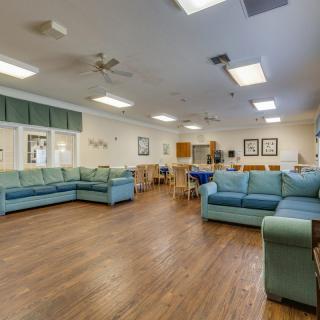 Spacious living area with comfortable couches and ample lighting.