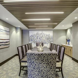 A modern dining room with sleek furnishings and elegant artwork.