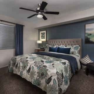 A stylish bedroom with floral bedding and modern decor.