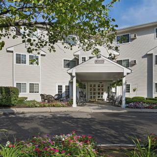 A residential building with a welcoming entrance and landscaped surroundings.