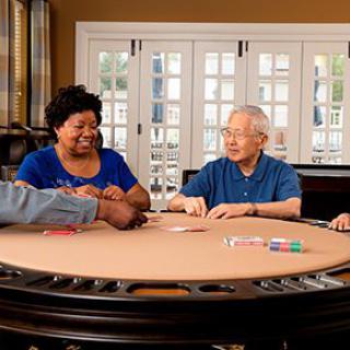 A group of people enjoying a game of poker around a table.