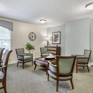 A cozy living room with elegant armchairs and a coffee table.