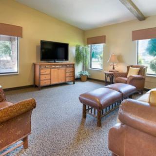 Spacious living room with comfortable seating and a television.