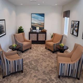 A cozy waiting room with comfortable chairs arranged in a circle.