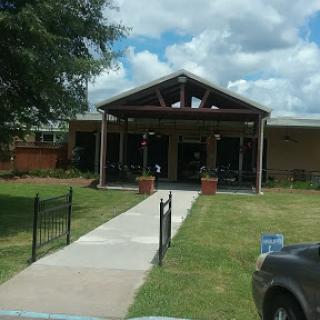 A welcoming entrance to a well-maintained building with landscaped surroundings.
