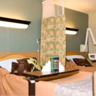 A hospital room with beds and medical equipment.