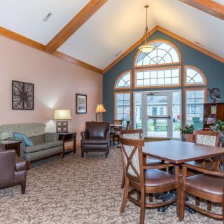 A cozy living room with comfortable seating and large windows.