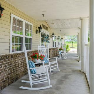 A charming porch with rocking chairs and potted plants, perfect for relaxing.