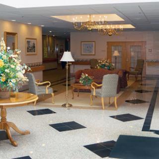 A spacious and elegantly decorated lobby featuring comfortable seating and floral arrangements.