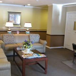 A cozy living room with comfortable couches, a coffee table, and warm lighting.