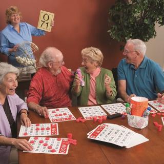 A group of seniors enjoying a lively bingo game together.