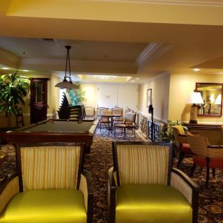 A cozy lobby area featuring seating, plants, and ambient lighting.
