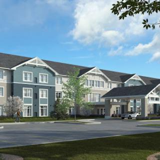 A modern residential building featuring a blend of architectural styles under a clear blue sky.