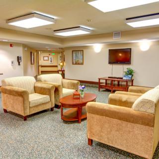 A cozy lobby area with comfortable seating and a television.