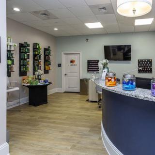 A modern office reception area with a curved desk and seating.