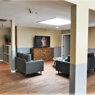 A modern living room with comfortable seating and a large television.