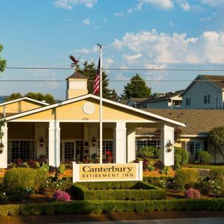 Entrance of Canterbury Village with well-maintained landscaping and a prominent sign.