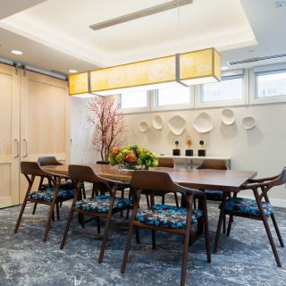 A modern dining room with a wooden table, contemporary chairs, and stylish decor.