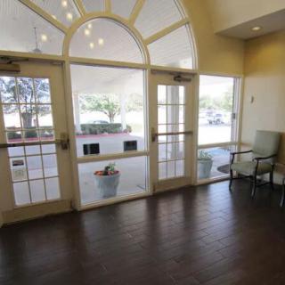 A well-lit lobby area with large windows and seating.