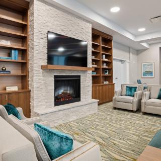 A modern living room with a fireplace, television, and comfortable seating.