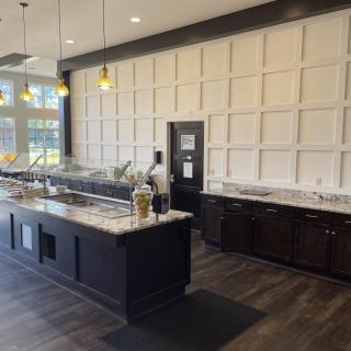 A modern kitchen interior with an island and stylish lighting.
