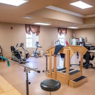 A rehabilitation room equipped with various exercise machines and therapy equipment.
