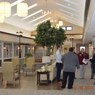 A spacious, well-lit lobby with people engaged in conversation.