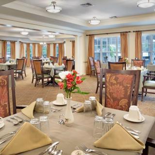 Elegant dining room with neatly arranged tables and chairs.