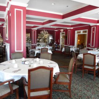 An elegant restaurant interior with neatly arranged tables and chairs.