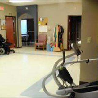 A rehabilitation facility with exercise equipment and mobility aids.