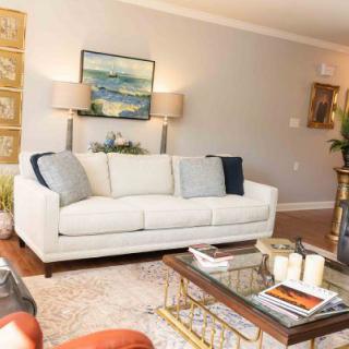 A cozy living room with a white sofa and stylish decor.
