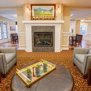 A cozy living room featuring a fireplace, comfortable seating, and elegant decor.