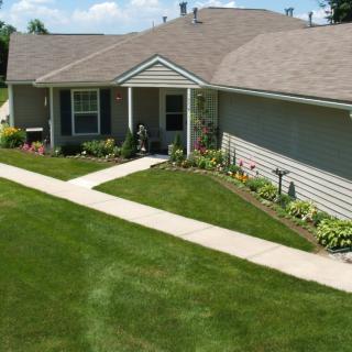 A suburban house with neatly maintained lawn and pathway.
