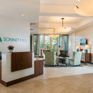 A spacious and well-lit reception area featuring comfortable seating and modern decor.