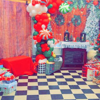 A vibrant and festive Christmas setup filled with balloons and gifts, perfect for holiday celebrations.