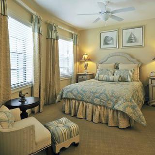 A cozy and elegantly decorated bedroom with classic furniture and soft lighting.
