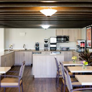 A modern kitchen area with wooden furniture and appliances.