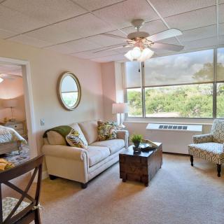 A cozy living room with comfortable seating and a large window letting in natural light.