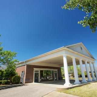 A picturesque building featuring classic architectural columns under a clear blue sky.