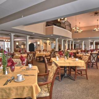 An elegant restaurant dining room with neatly arranged tables and beautifully decorated interiors.
