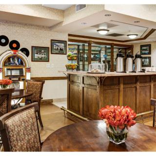 A cozy cafe interior featuring a jukebox and a bar area with coffee dispensers.