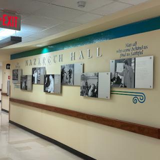 A hallway in a hospital showcasing a dedicated 'Research Hall' with framed photographs.