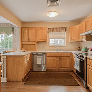 A cozy kitchen with wooden cabinets and modern appliances.