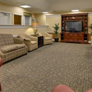 A cozy living room with a television and comfortable seating.