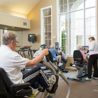 Seniors engaging in fitness activities at a gym.