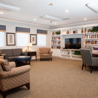 A cozy living room with comfortable seating and a large television.