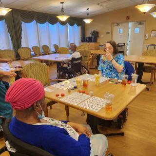 Residents in a care home enjoying a game of bingo together.