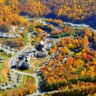 A stunning aerial view of a picturesque landscape showcasing vibrant autumn foliage.