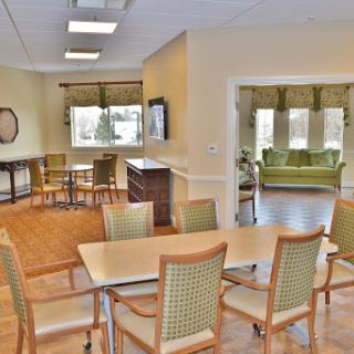 A spacious and well-lit common area featuring dining and relaxing spaces.